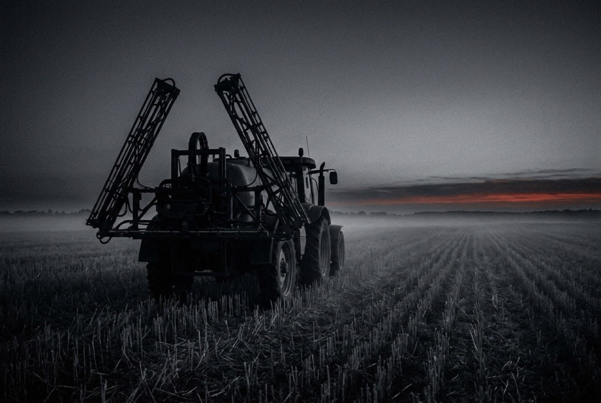 Agricultural field under herbicide spraying equipment (photo illustration)