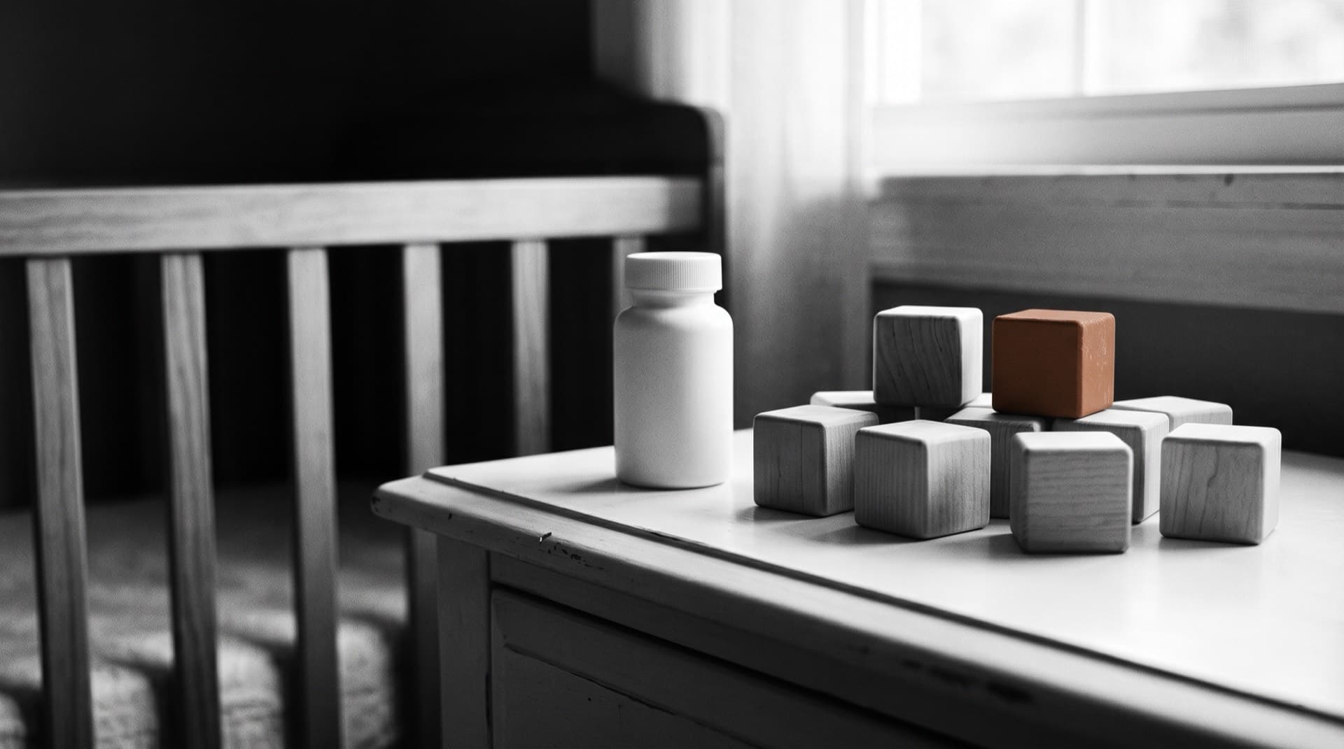A medicine bottle beside wooden blocks on a nursery dresser (photo illustration)
