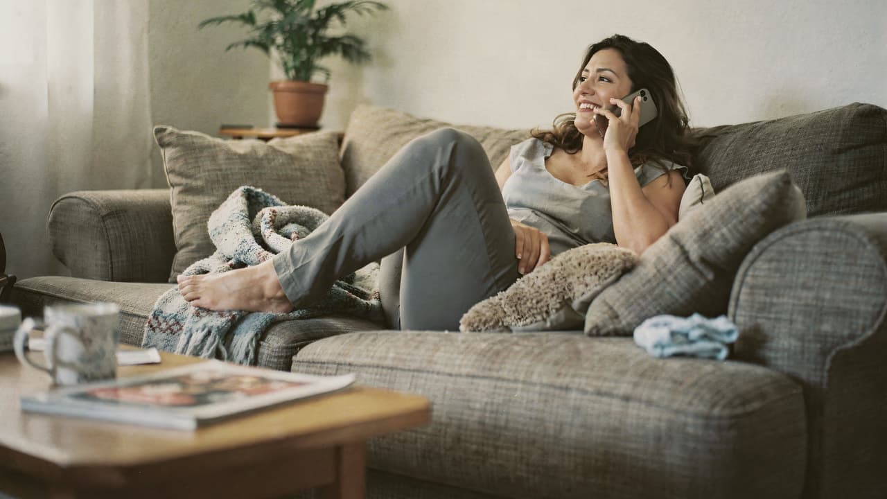 Woman answering questions on her phone, smiling