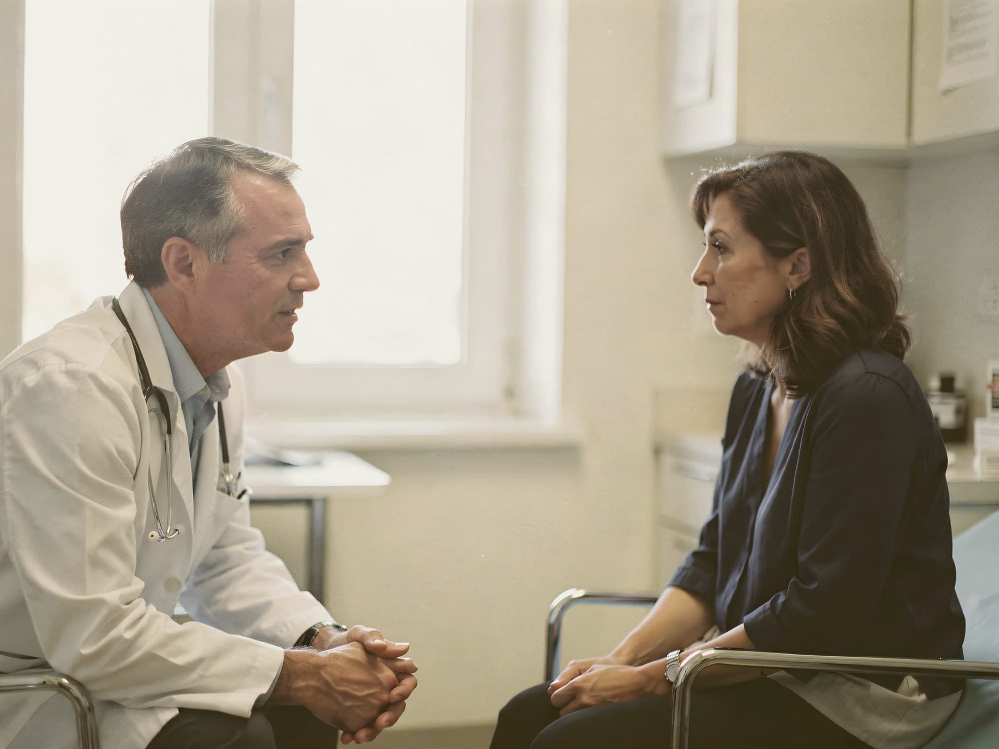 Neurologist or primary-care doctor talking with a woman patient, reviewing results together